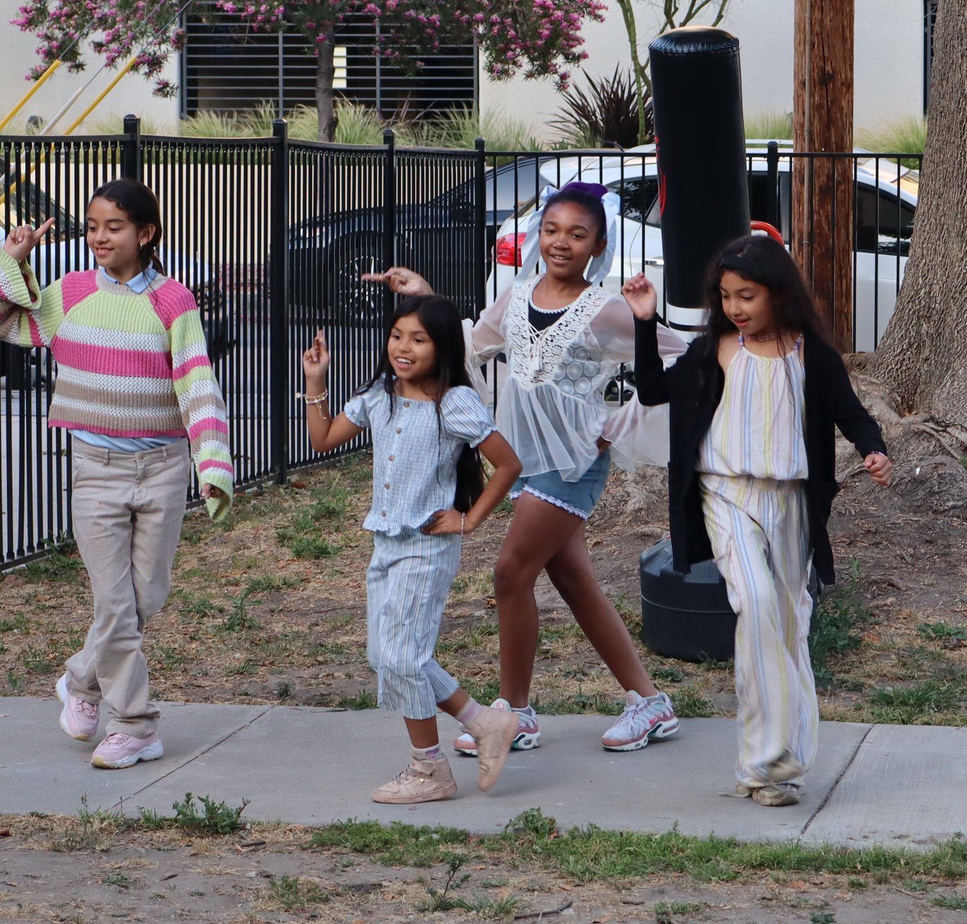 Four students mid-move in a dance routine