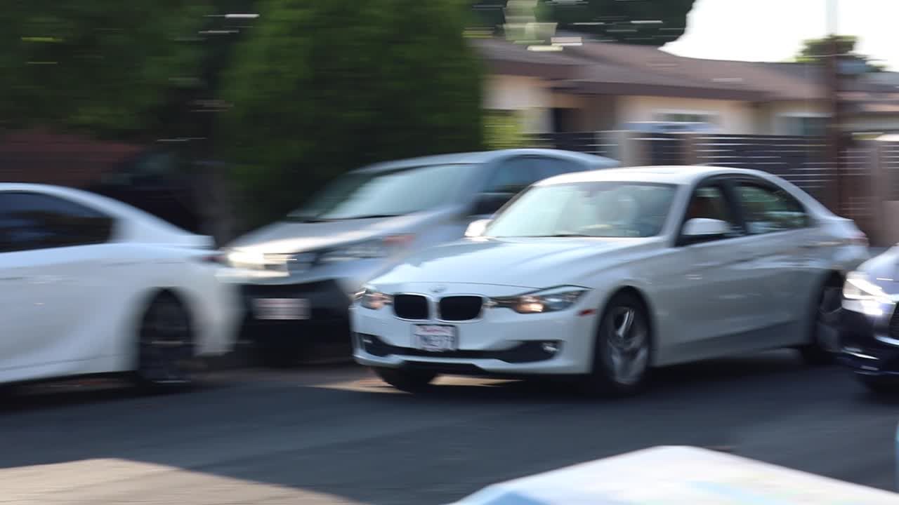 Two teens leaning on a car in the film Fast and Hungry