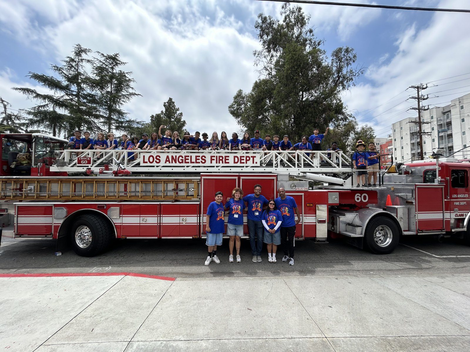 Campers in blue Hands4Hope LA shirts on a Los Angeles Fire Department truck