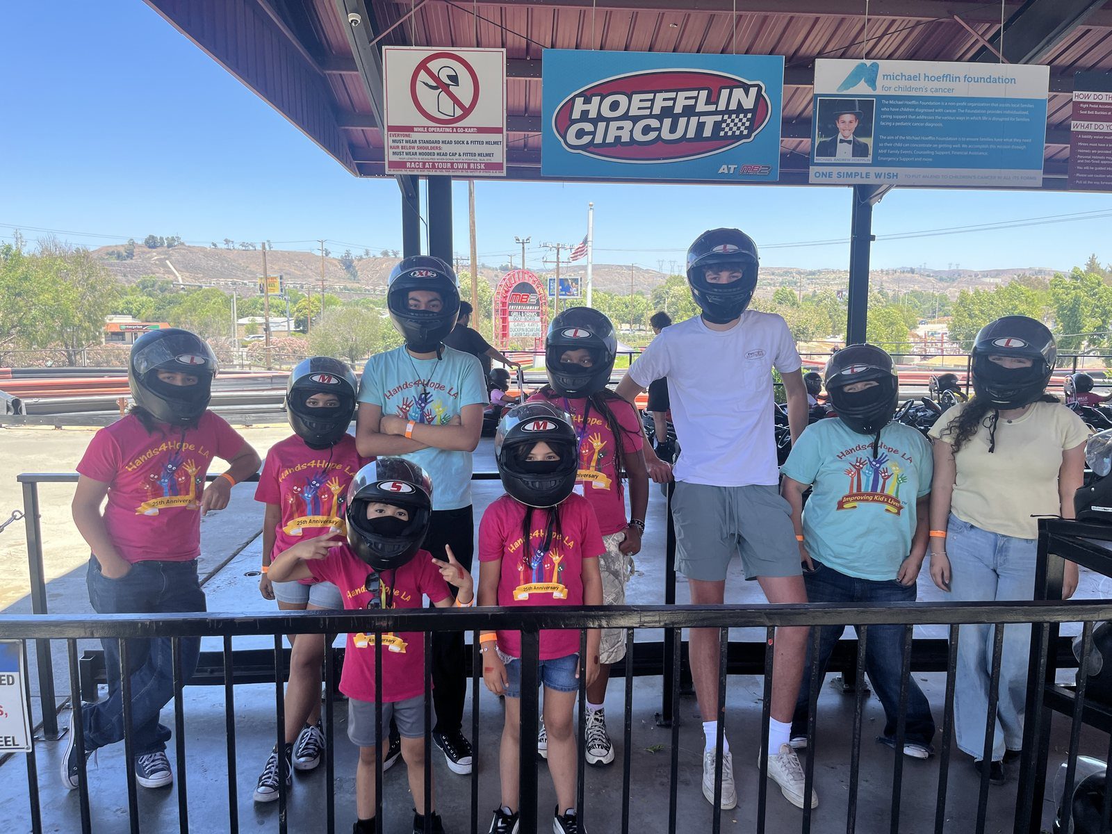 Campers riding go-karts on a summer field trip