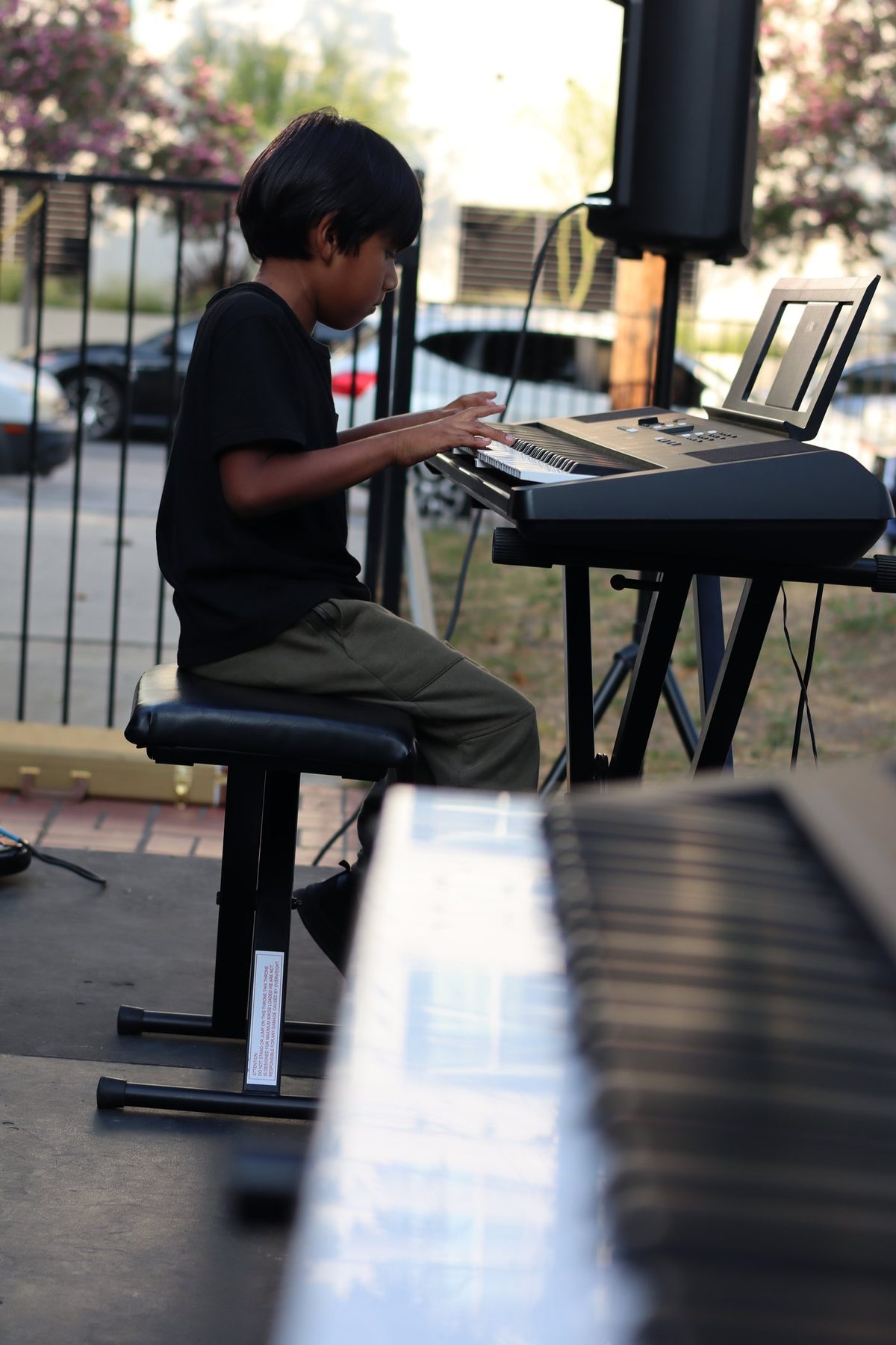 A student playing keyboard on the showcase stage